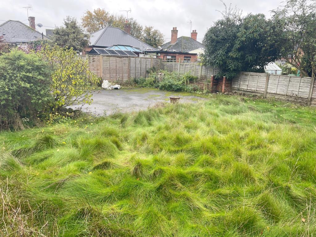 Lot: 2 - DETACHED FOUR BEDROOM CHALET BUNGALOW IN POPULAR VILLAGE - Part rear garden showing hard standing